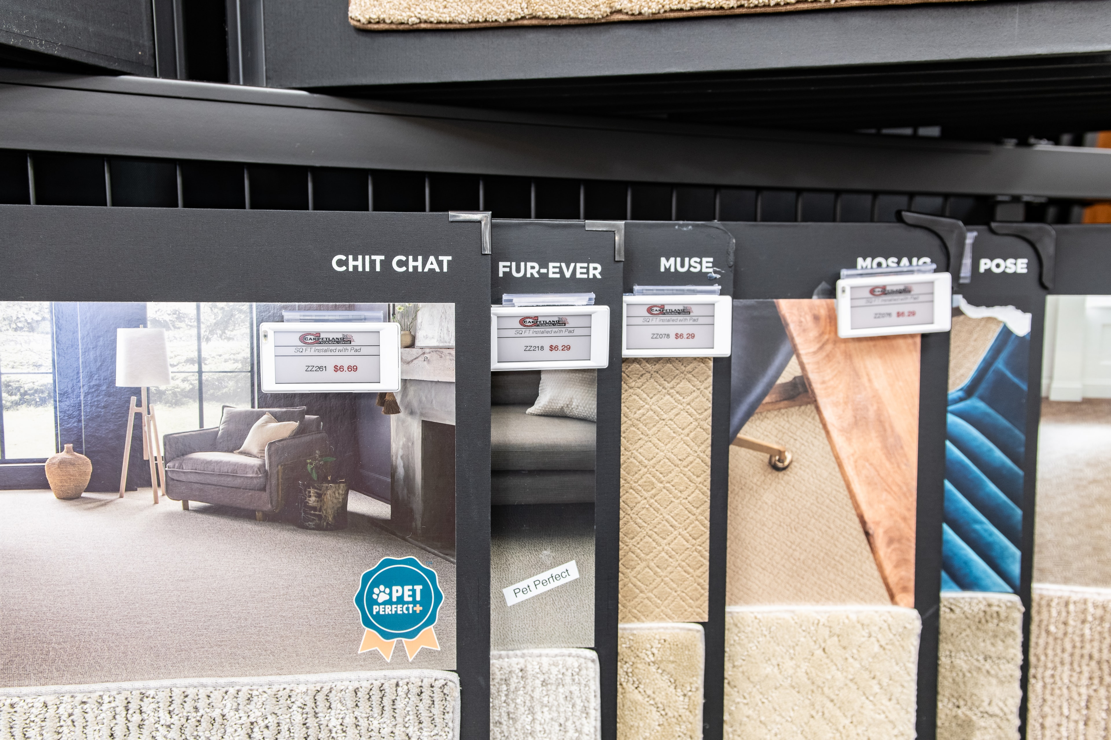 Carpetland USA – carpet sample display wall with ESL price tags