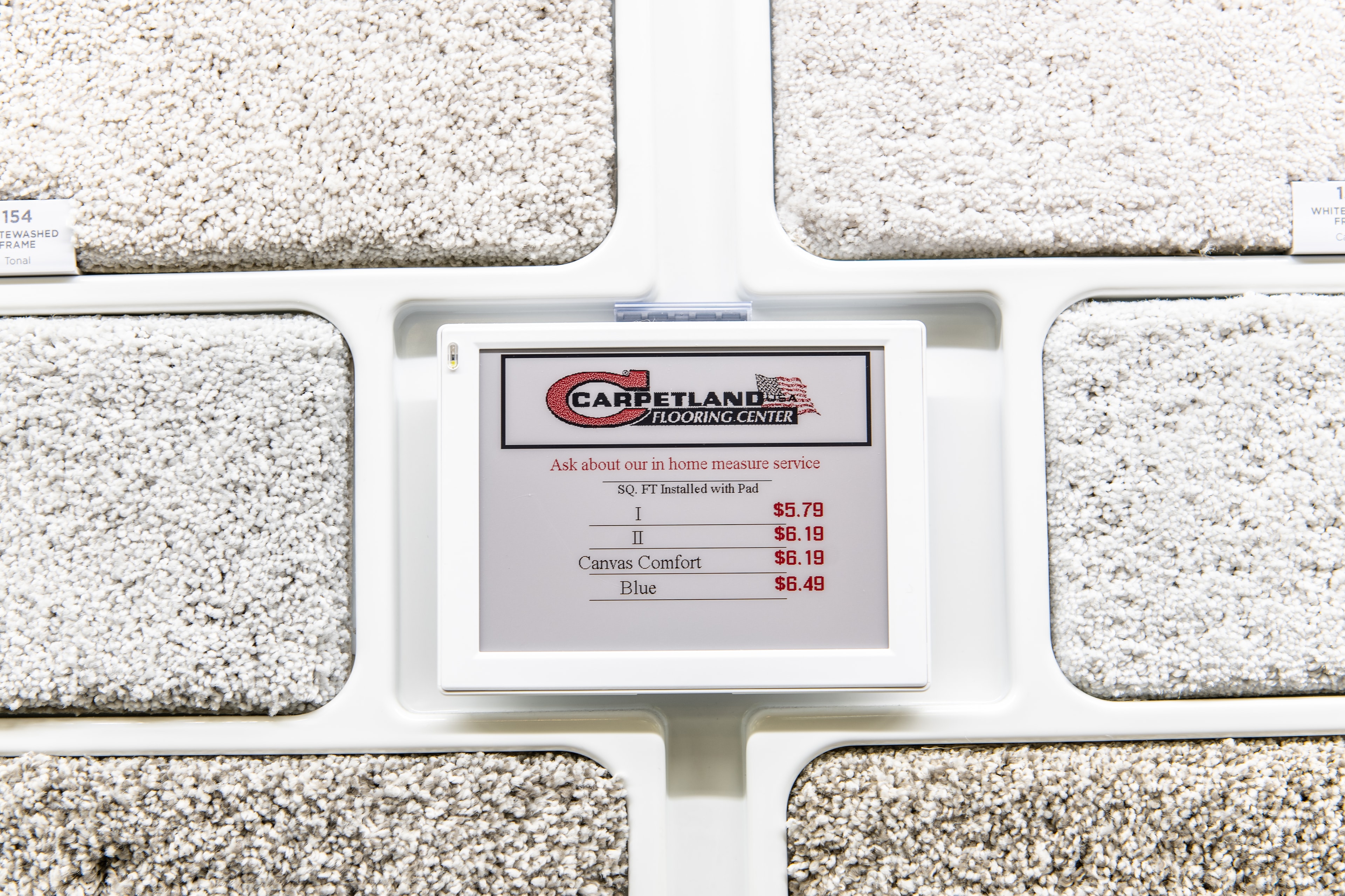 Carpetland USA – carpet sample wall with Carpetland Flooring Center ESL tag