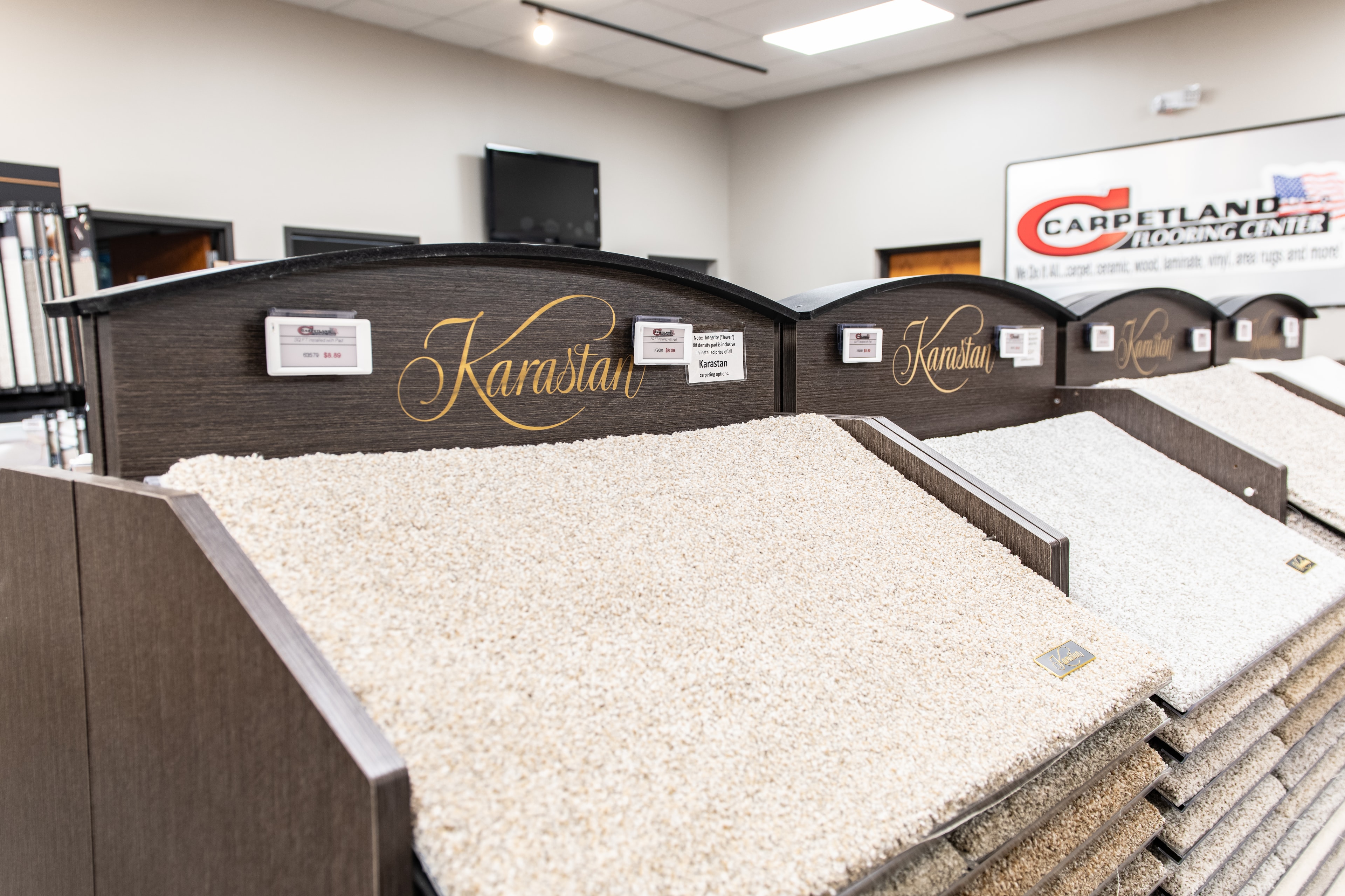 Carpetland USA – Karastan carpet showroom display with ESL labels
