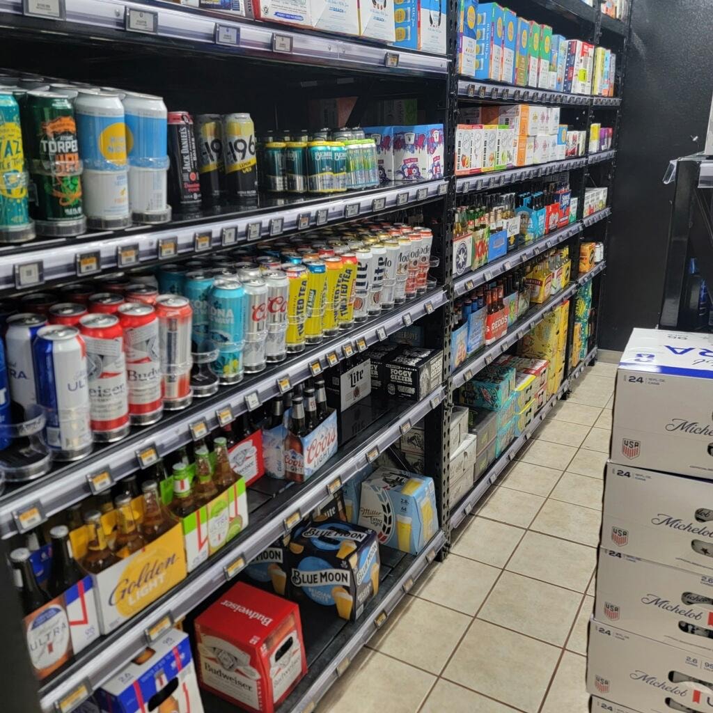 Petro Serve USA – beer and beverage cooler aisle with ESL pricing