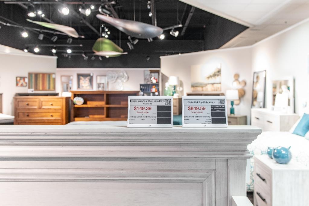 Steinhafels – showroom floor with ESL tags on crib mattress $149.39 and Stella Flat Top Crib $849.59
